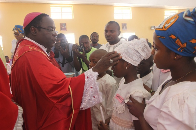 Bishop Kukah administer the sacrament of confirmation