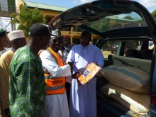 Fr. Lawrence presenting items to SEMA
